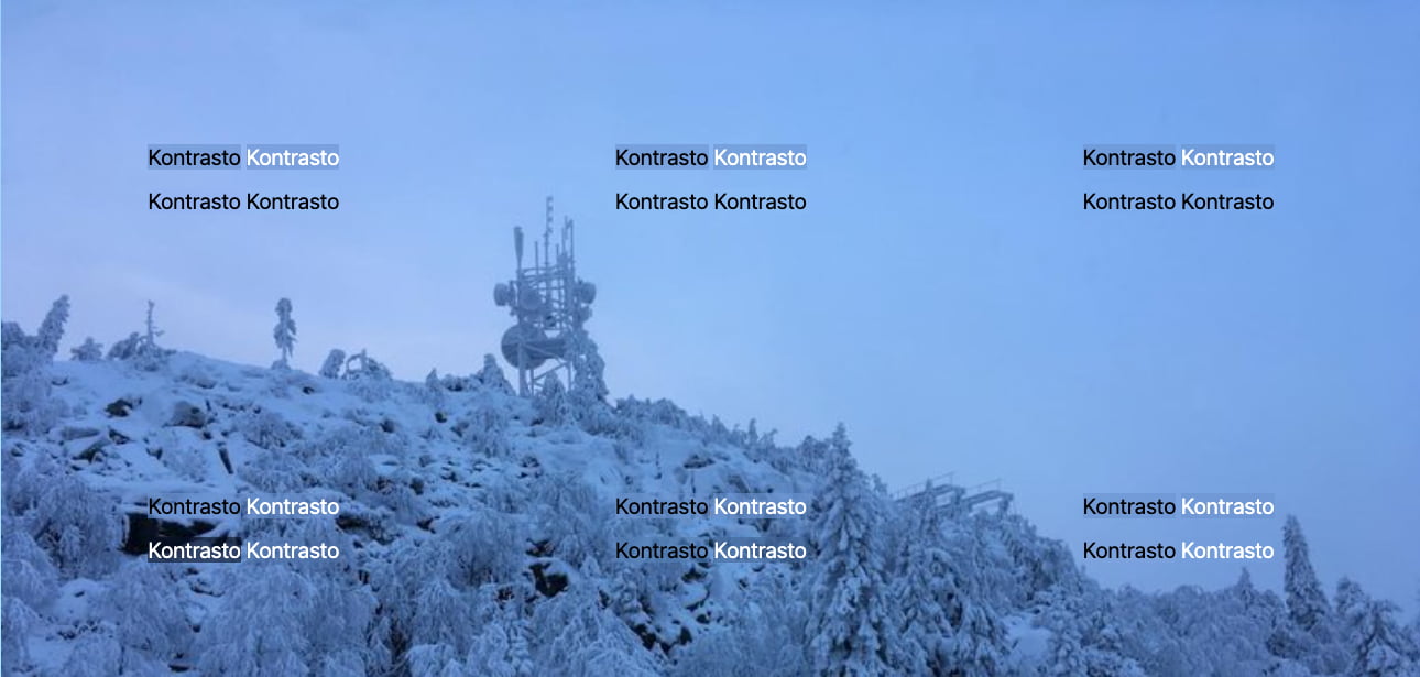 Snow-covered landscape with snow-covered trees, blue-white sky, and a snow-covered radio tower on the horizon